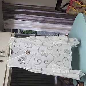 Mirror image white tunic cover up to sheer top.